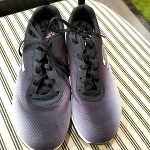 Sketchers womansNWOT.  Sz 8 Never worn. They have a purple hue in light